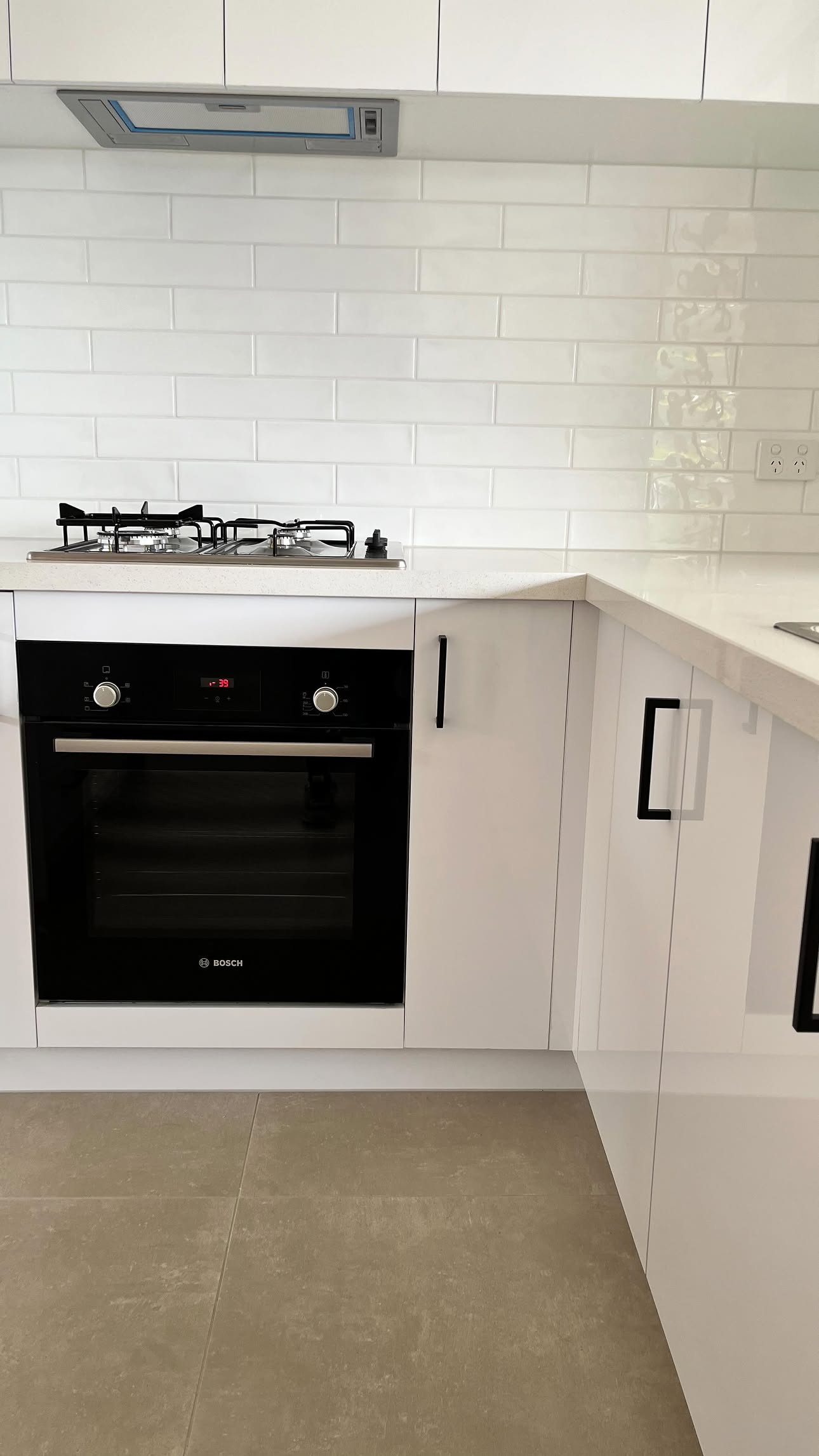 White kitchen with Bosch oven and gas cooktop