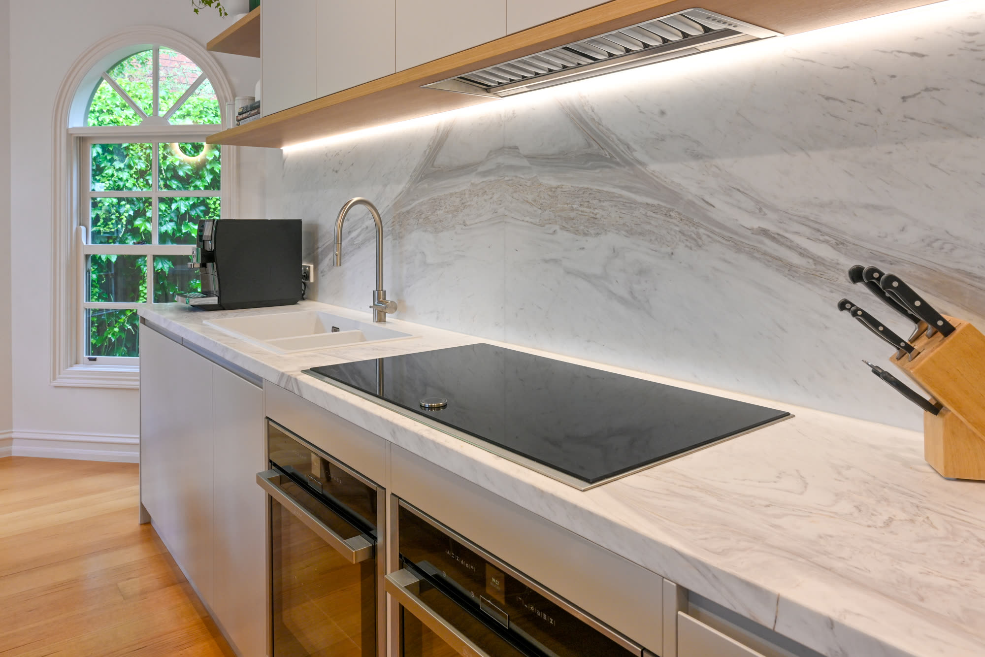 Marble waterfall benchtop with integrated appliances