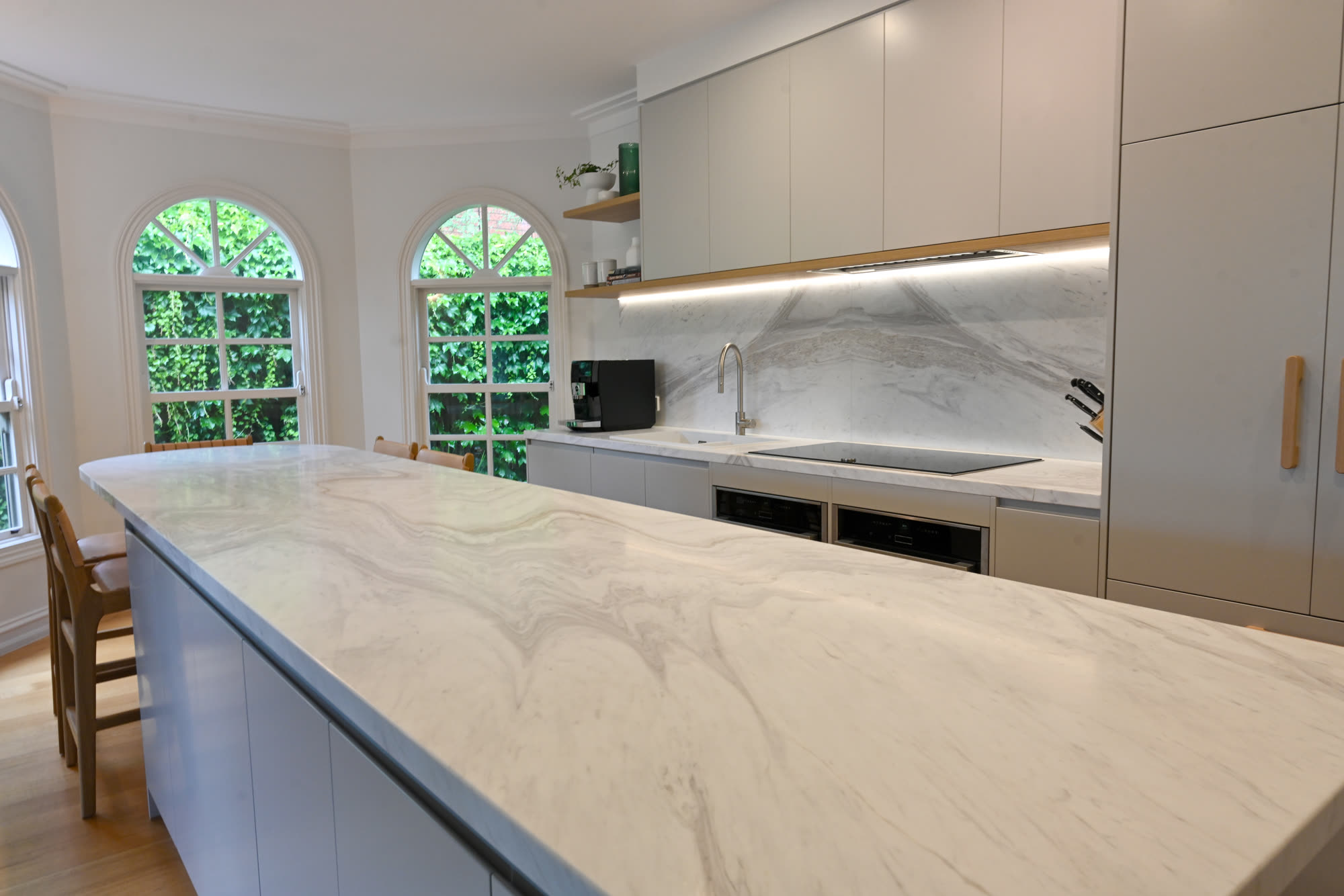 Custom blue island cabinetry with marble top